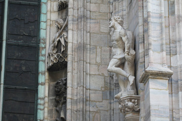 The marvellous statue are decorating on the white wall surrounding Duomo milano, The mistery art on external building of Famous white Architectural cathedral church at Milan, Largest church in Italy
