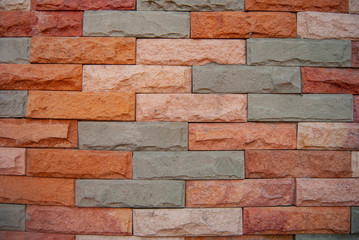 Background, exterior wall of the building Forming walls and adorned with colored sandstone