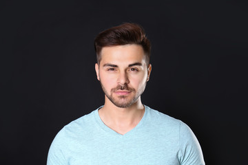 Portrait of handsome man on black background