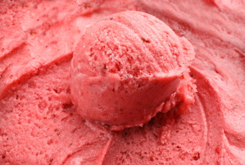Scoop of delicious strawberry ice cream in container, closeup