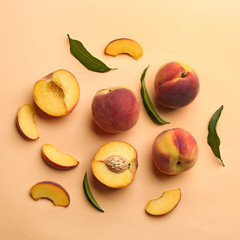 Flat lay composition with fresh peaches on beige background