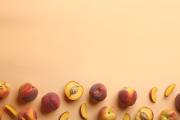Flat lay composition with fresh peaches on beige background. Space for text