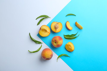 Flat lay composition with fresh peaches on color background
