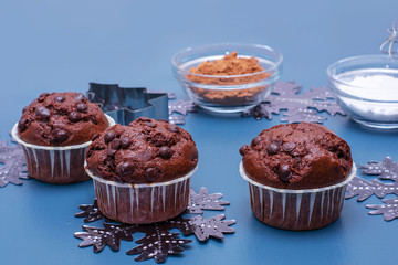 Cupcakes and ingredients on a light background. Bake a cupcake for christmas