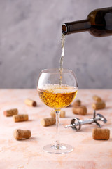 White wine is poured into a glass. The concept of winemaking. Place under your text.