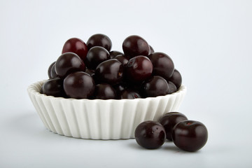 Fresh cherry on plate on wooden blue background. fresh ripe cherries. sweet cherries.