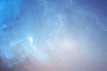 Blue smoke over black studio background
