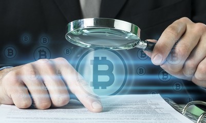 Business analytics and statistics. Businessman with report using a magnifying glass.