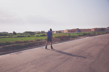 man with inline skates skating on the street
