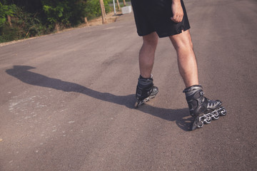 man with inline skates skating on the street