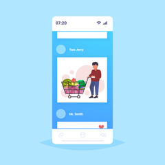 man grocery shop customer pushing trolley cart with groceries vegetables and fruits shopper buying products shopping concept smartphone screen mobile app flat full length