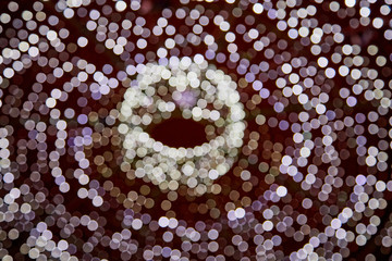 Abstract texture with light round white bokeh and black background. Blurred circle
