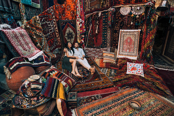 Happy couple in the store. Couple in love in Turkey. Man and woman in the Eastern country. Gift shop. A couple in love travels. Persian shop. Tourists in store. Oriental carpet. Istanbul. Cappadocia