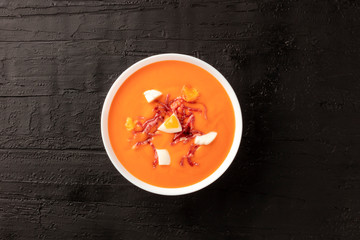 Salmorejo, Spanish cold tomato soup, shot from above on a black background with a place for text