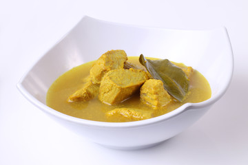 fish curry in a white bowl clean background