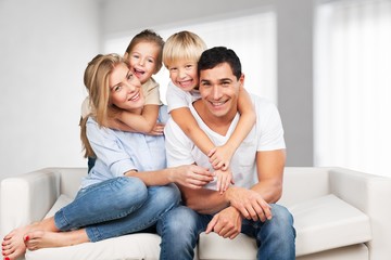 Young family at home smiling at camera