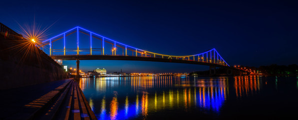 Night panorama of pedestrian bridge on Dnipro in Kiev Ukraine