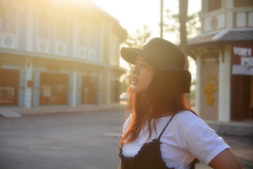 Portrait of a young Asian girl long hair wear hat at home with morning light, expressing freedom...