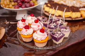 White sweet cupcakes on the white stand