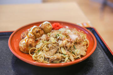 takoyaki, octopus balls, and yakisoba, Japanese fried noodle, in a plate