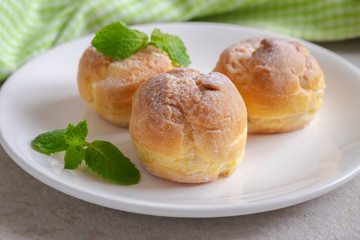 Cream puffs on white plate