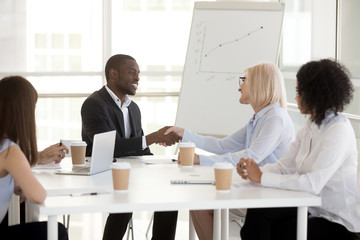 African American businessman shake hand of colleague at business briefing
