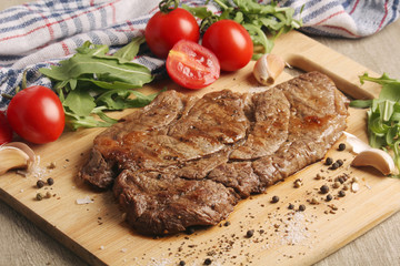 A beef steak well done with vegetables