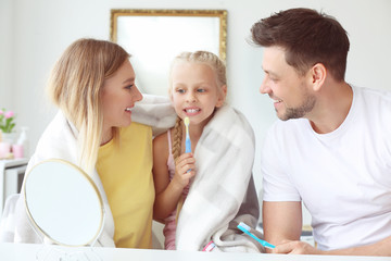 Family cleaning teeth at home