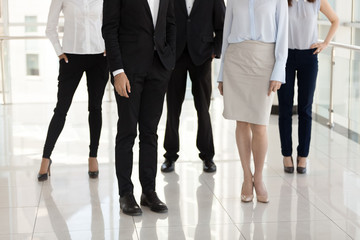 Fototapeta na wymiar Feet of diverse employees or managers standing in office hallway