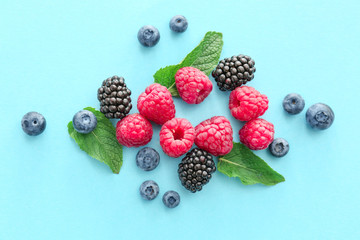 Sweet ripe berries on color background