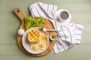Composition with tasty squash waffles and fried eggs on table