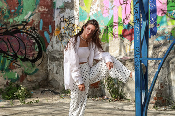 Young beautiful lady wearing a stylish white top.Portrait shooting of a stylish girl.Trends summer 2019.