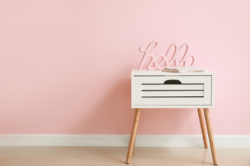 Table with decor near color wall