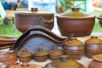 traditional and modern style handmade ceramic clay plates, pots and pans on sale at ethno festival fair