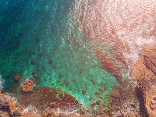 Mediterranean Sea with turquoise water beats on coast of island of Malta. Aerial top view