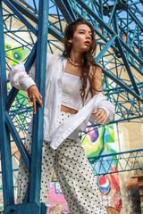 Young beautiful lady wearing a stylish white top.Portrait shooting of a stylish girl.Trends summer 2019.