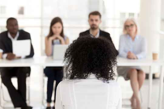 African American female applicant at job interview rear view