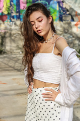 Young beautiful lady wearing a stylish white top.Portrait shooting of a stylish girl.Trends summer 2019.