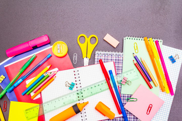 Back to school concept. School education supplies on black stone concrete background.