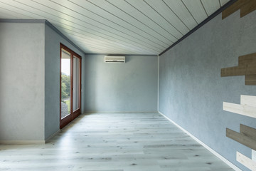Empty room with grey walls and parquet