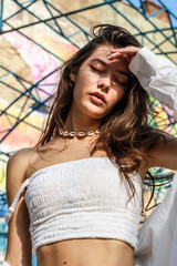 Young beautiful lady wearing a stylish white top.Portrait shooting of a stylish girl.Trends summer...