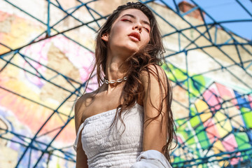 Young beautiful lady wearing a stylish white top.Portrait shooting of a stylish girl.Trends summer...