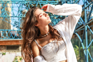 Young beautiful lady wearing a stylish white top.Portrait shooting of a stylish girl.Trends summer...