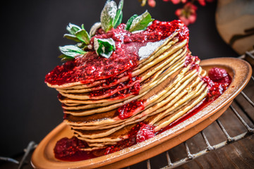 American pancakes with raspberry syrup and mint.