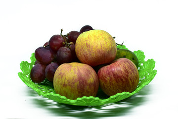 Fresh juicy fruits on the plastic tray, isolated on white background
