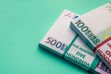 Two packs of euro banknotes. A bundle of banknotes of 500 euros and a bundle of banknotes of 100 euros.