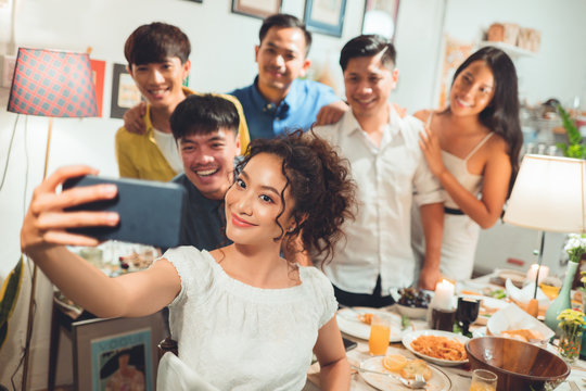 Group friends asian are taking selfies while eating dinner.