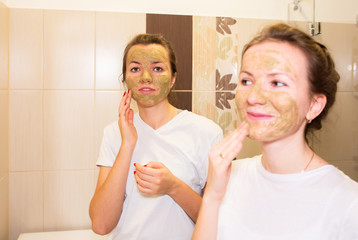 Girls are making clay masks for skin. Beauty procedures at home. Hen party.