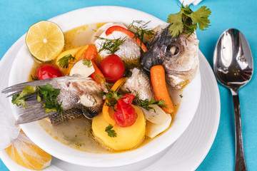 Mediterranean sea-fish soup with vegetables and lemon