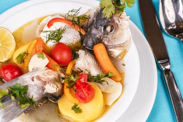 Mediterranean sea-fish soup with vegetables and lemon